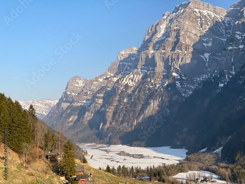 Frozen Klöntalersee or Klontaler Lake during early spring in the Alpine valley Klöntal (Kloental or Klontal) and in the Glarus Alps mountain massif - Canton of Glarus, Switzerland (Schweiz) photo