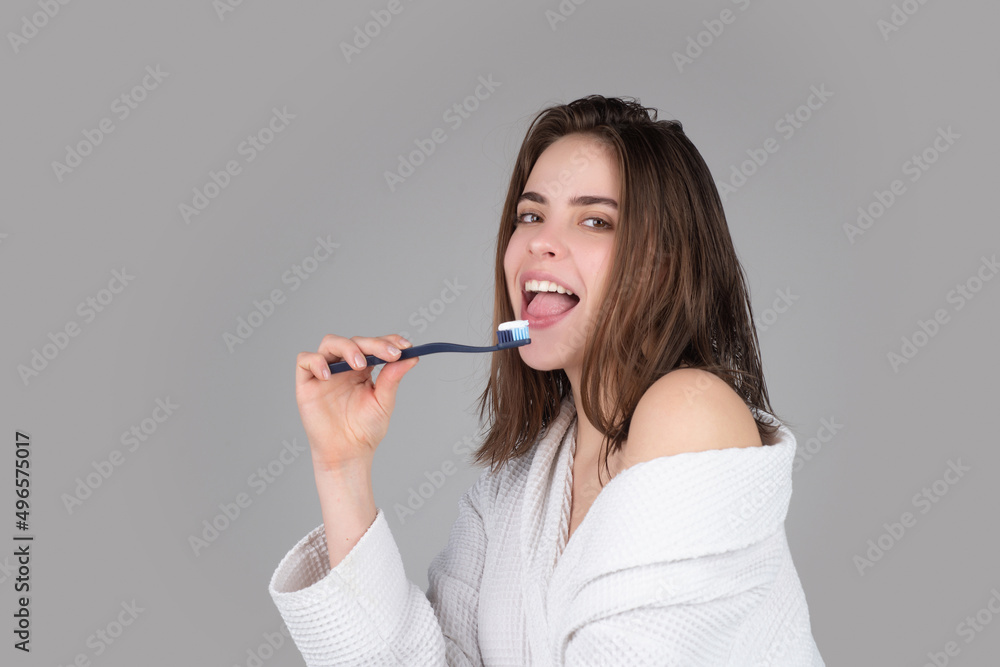 Closeup portrait of womans toothy smile against a isolated background with copy space. Girl brushing her teeth. Beautiful young woman smile. Dental health. White tooth. Closeup portrait of womans toothy smile against a isolated background with copy space. Girl brushing her teeth. Beautiful young woman smile. Dental health. White tooth.