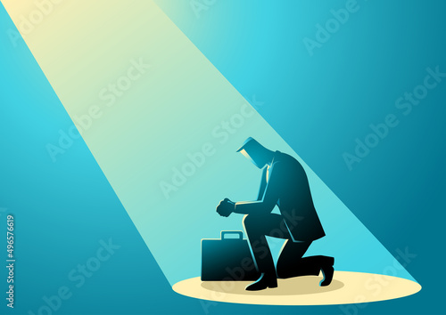 Businessman is praying with light on him