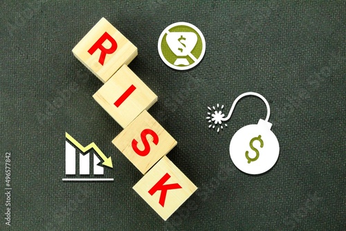 wooden cubes with risk icons and the word risk. The concept of business risk