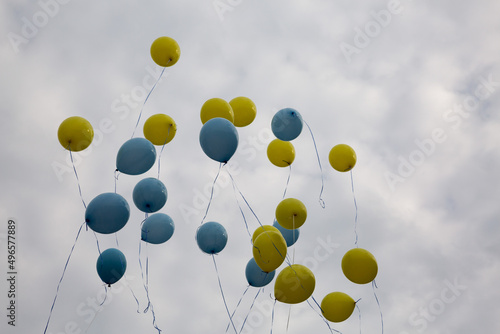 Yellow and Blue Balloons Flying to the Sky