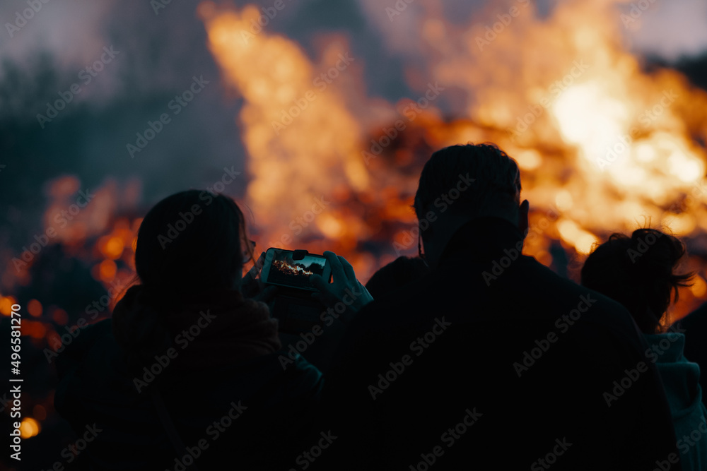 silhouette of people in front of easter bonfire