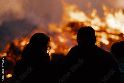 silhouette of people in front of easter bonfire