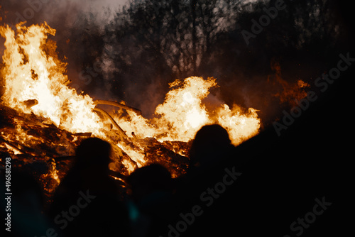 silhouette of people in front of easter bonfire