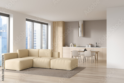 Light kitchen interior with couch and eating table, panoramic window