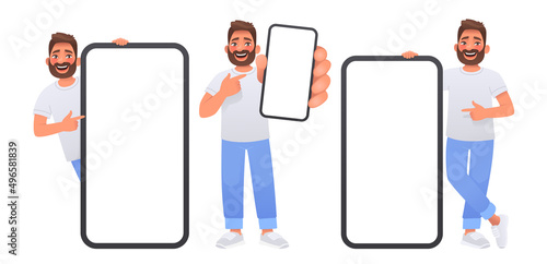 Happy man points to the screen of a huge smartphone. Advertising of a mobile app or services