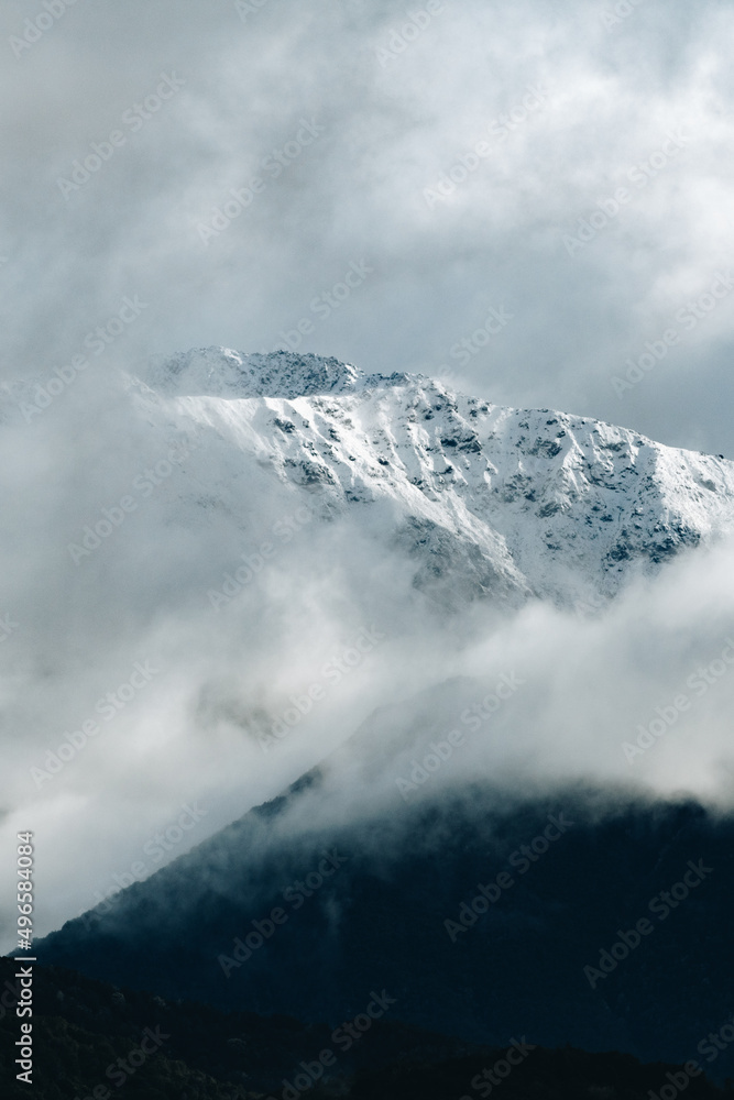 Snow covered peaks with clouds