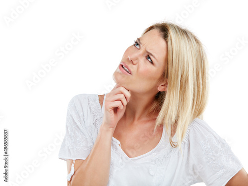 I dont get it. Studio shot of a young woman looking confused against a white background.