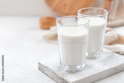 Two glasses of milk on a white background. Side view, copy space.