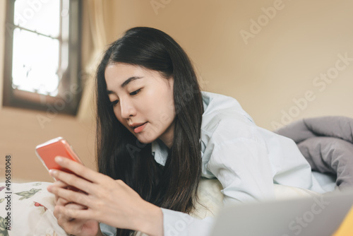 Young adult single woman using smartphone in the morning for online app mental health.