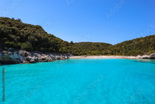 Fototapeta Naklejka Na Ścianę i Meble -  Scenic View of Ionian Sea with Blue Sky in Antopaxos. Tursquoise Water in Corfu. Beautiful Scenery with Beach Shore in Antipaxoi.