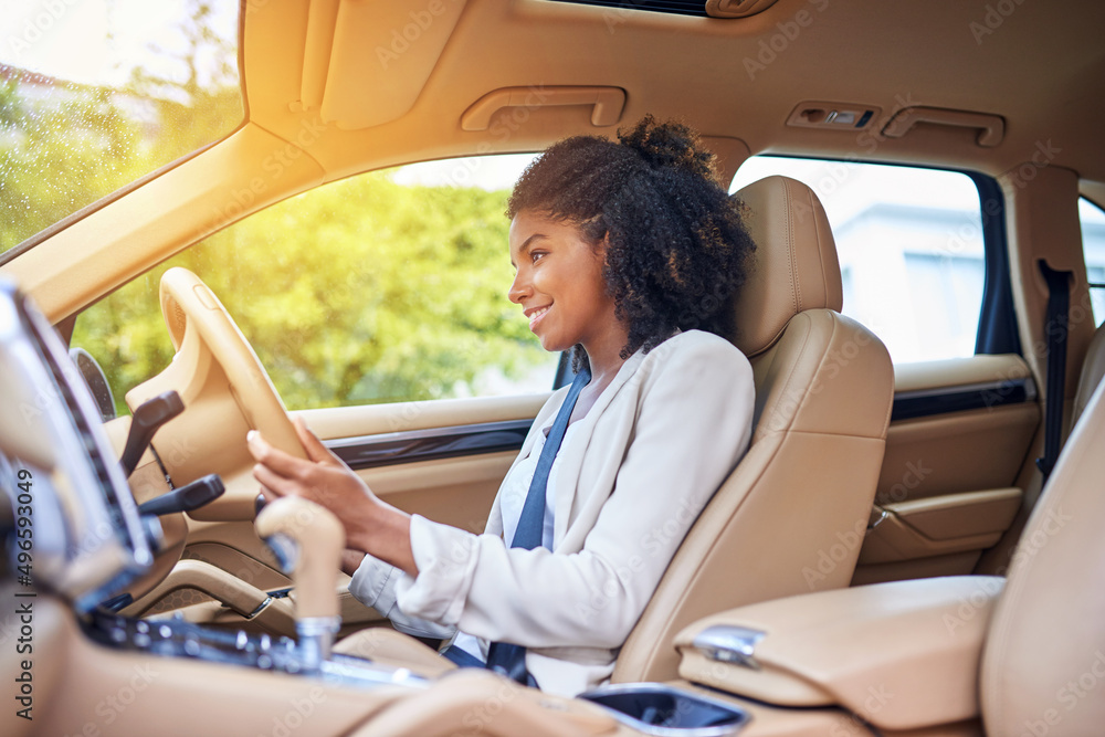 She enjoys her morning commute. Cropped shot of an attractive young businesswoman driving to work on her morning commute. She enjoys her morning commute. Cropped shot of an attractive young businesswoman driving to work on her morning commute.