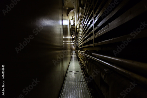 Fototapeta Naklejka Na Ścianę i Meble -  A long, narrow gloomy tunnel on a ship.