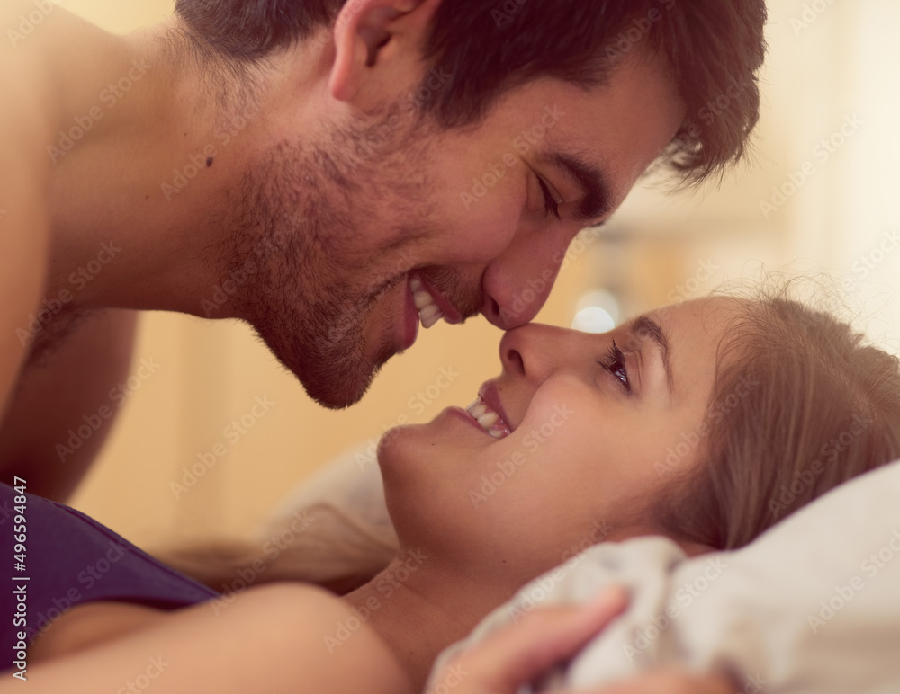Fanning the spark of love. Shot of a loving young couple getting intimate in bed. Fanning the spark of love. Shot of a loving young couple getting intimate in bed.
