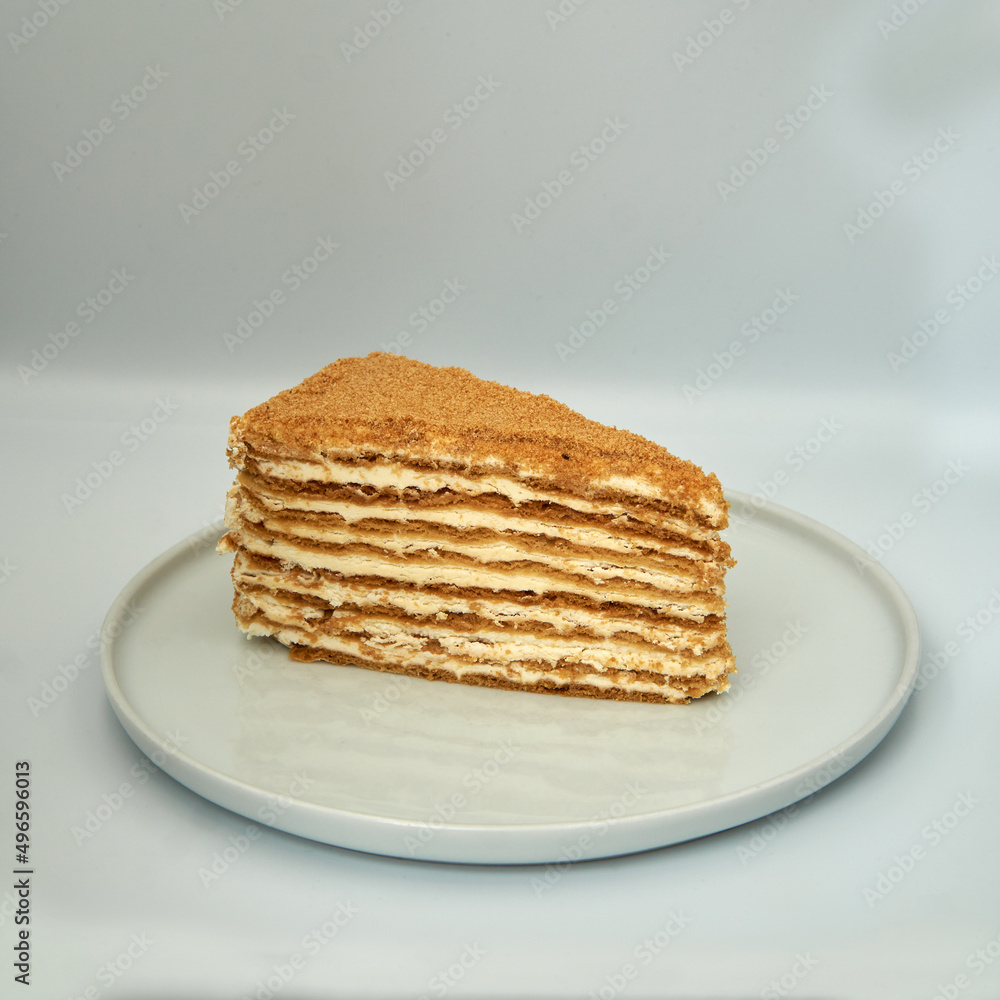 Stack of sweet creamy pancakes on a plate on isolated white background.