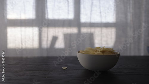 Fototapeta Naklejka Na Ścianę i Meble -  potato chips in white bowl on oak table