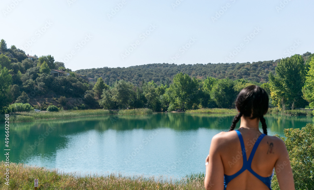 girl from behind looking at one of the ruidera lagoons in the natural park
