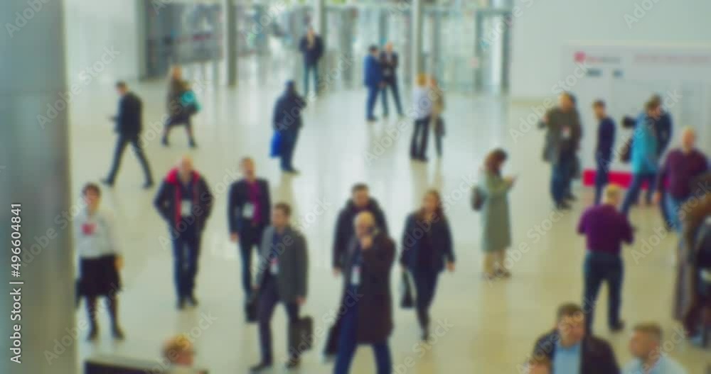 blurred defocused video on the topic of business.a crowd of people in a large hall.