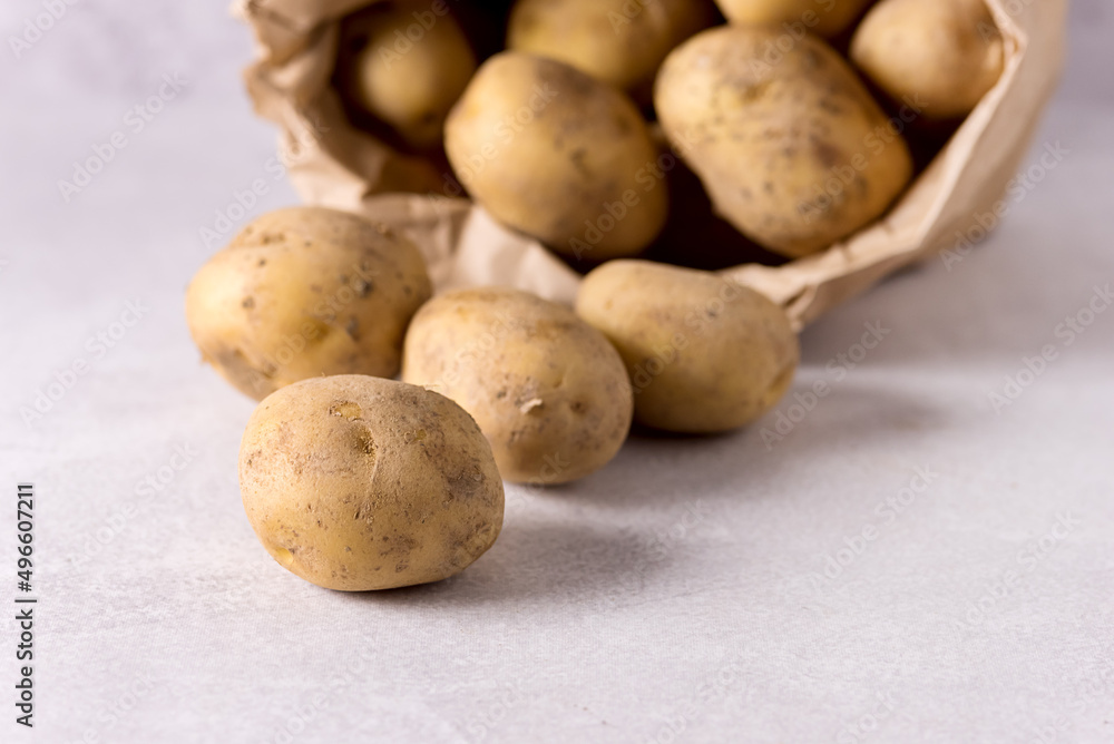 Raw Potato Food Fresh Potatoes in Craft Package on Light Gray Background Horizontal Raw Potato Food Fresh Potatoes in Craft Package on Light Gray Background Horizontal