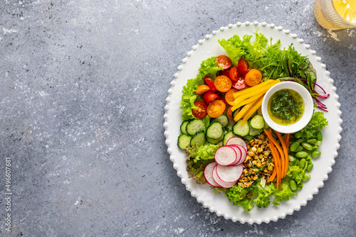 Healthy chopped salad with fresh vegetables, sprouts and sauce. Concept clean eating. Top view.