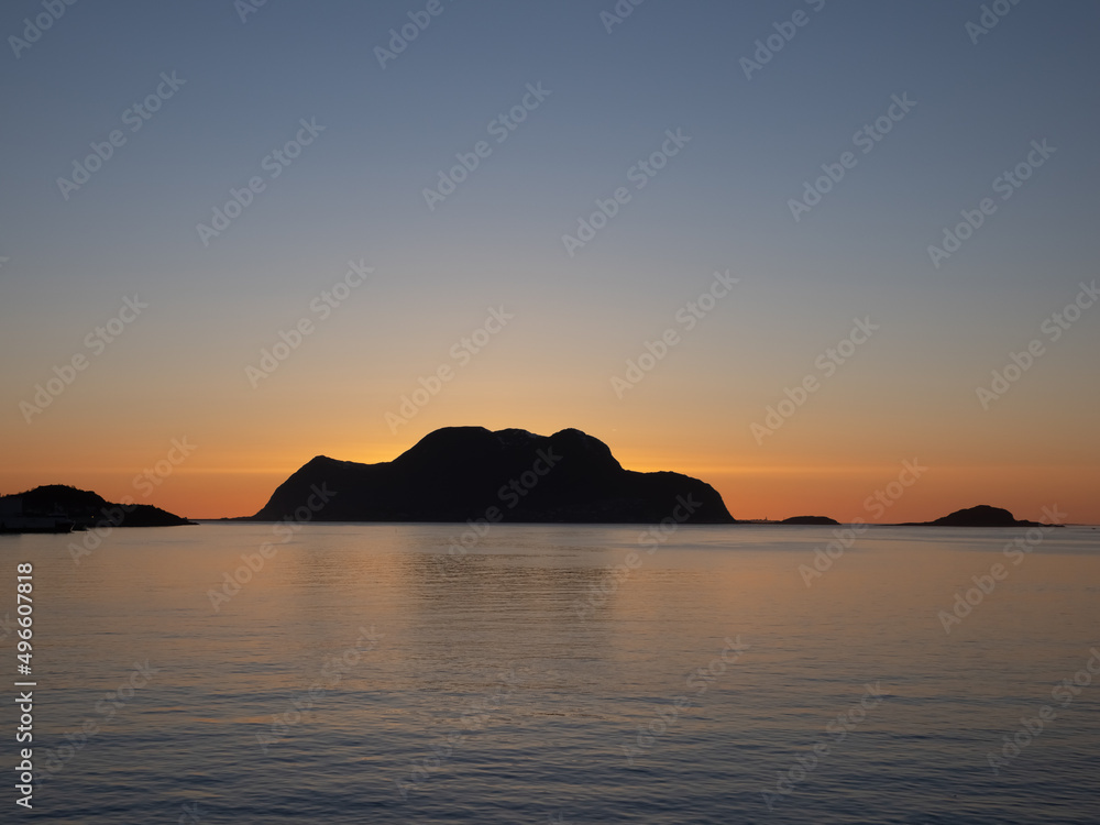 Naklejka premium Stunning sunset along the breathtaking fjords, skerries and islands of the Norwegian Western Coast near Ålesund, Møre og Romsdal, Norway.