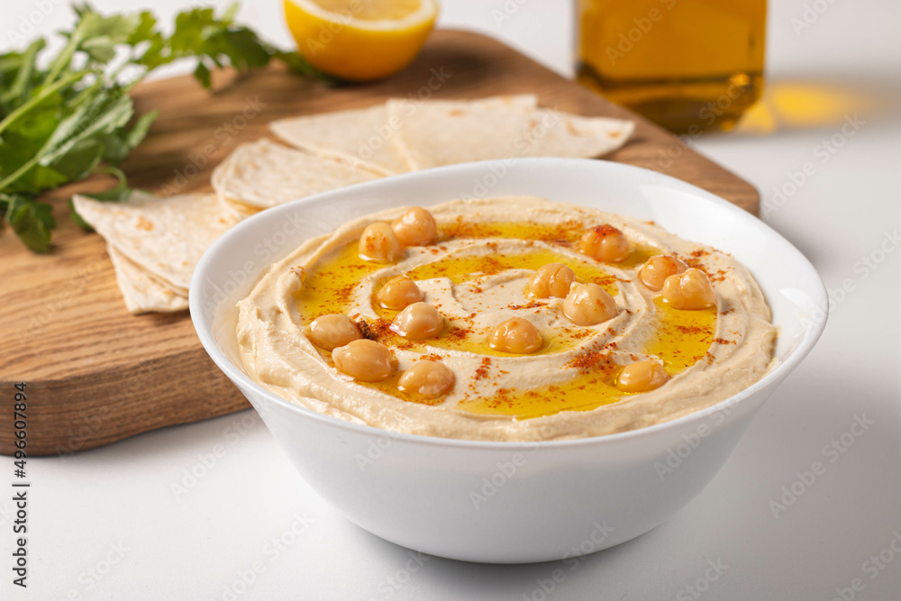 Delicious hummus with chickpeas, olive oil, lemon and pita bread. Vegetarian food concept. Delicious hummus with chickpeas, olive oil, lemon and pita bread. Vegetarian food concept.
