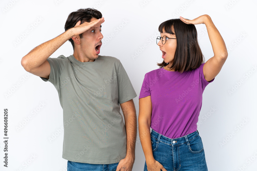 Young couple isolated on isolated white background with surprise and shocked facial expression Young couple isolated on isolated white background with surprise and shocked facial expression