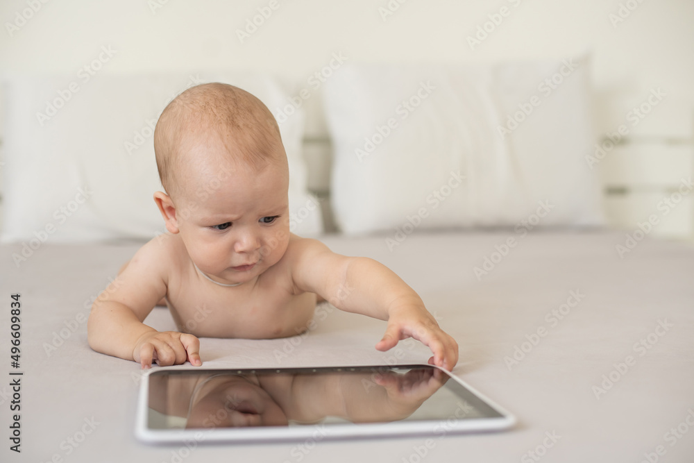 baby boy playing with digital tablet isolated on white baby boy playing with digital tablet isolated on white