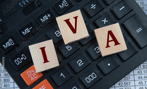 IVA - acronym on wooden cubes on the background of a calculator photo