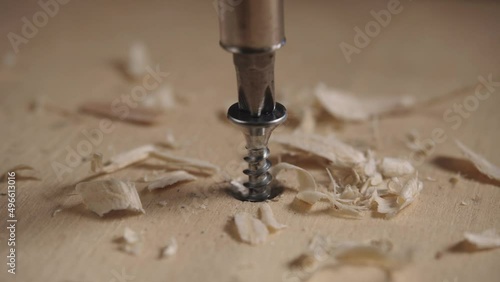 Close up of drilling into wood with screw twisted into place. Cordless drill photo