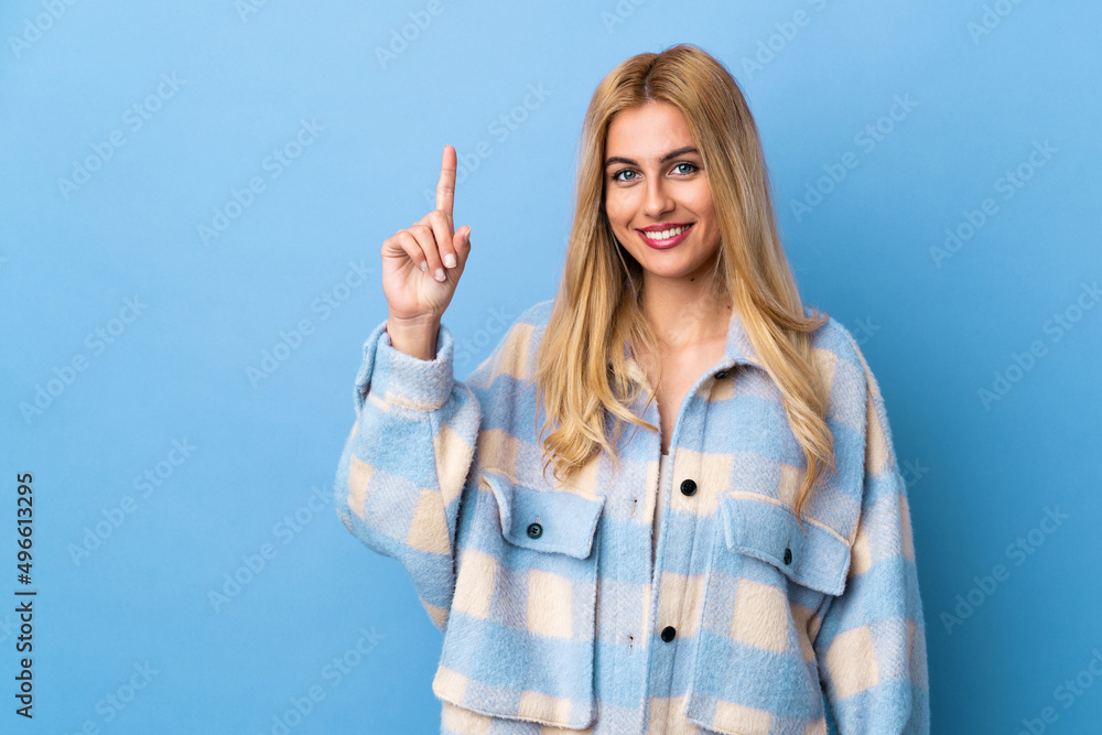 Young Uruguayan blonde woman over isolated background pointing up a great idea Young Uruguayan blonde woman over isolated background pointing up a great idea