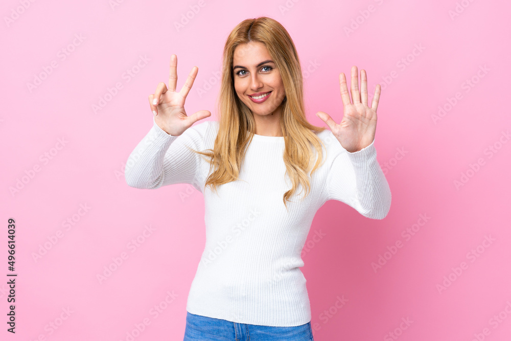 Young Uruguayan blonde woman over isolated pink background counting eight with fingers Young Uruguayan blonde woman over isolated pink background counting eight with fingers