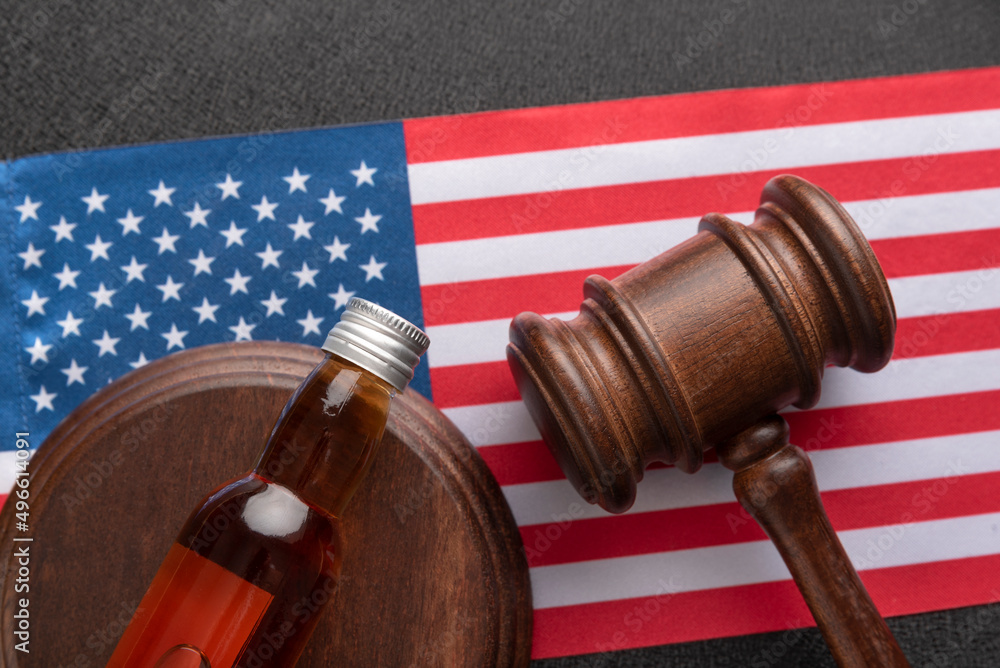Law hammer, alcohol and the U.S. flag. Legal problems with alcohol in United States of America. Alcohol and crimes concept.