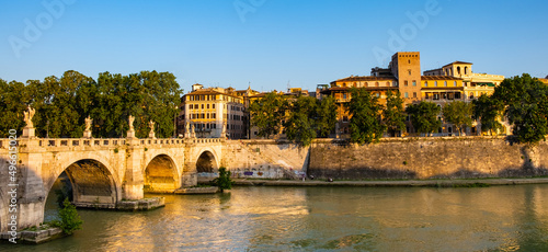 Panoramic view of Tiber river and Lungotevere Tor di Nona embankment aside Ponte Sant'Angelo Saint Angel Bridge in historic city center of Rome in Italy