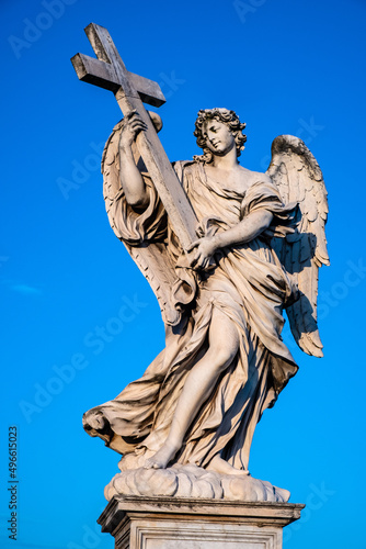 Angel with the Cross statue by Ercole Ferrata on Ponte Sant'Angelo Saint Angel Bridge over Tiber river in historic center of Rome in Italy photo