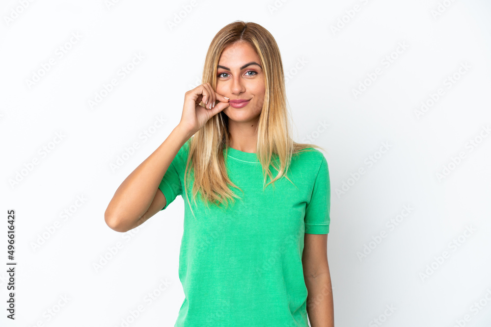 Blonde Uruguayan girl isolated on white background showing a sign of silence gesture Blonde Uruguayan girl isolated on white background showing a sign of silence gesture