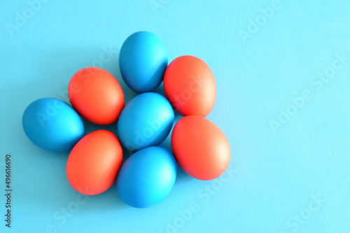easter eggs painted in blue and red on blue background  close-up