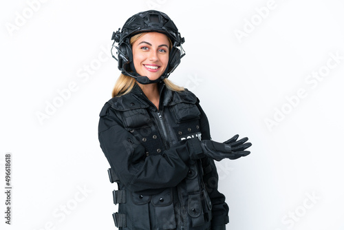 SWAT caucasian woman isolated on white background presenting an idea while looking smiling towards