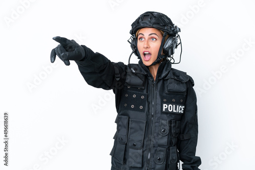 SWAT caucasian woman isolated on white background pointing away