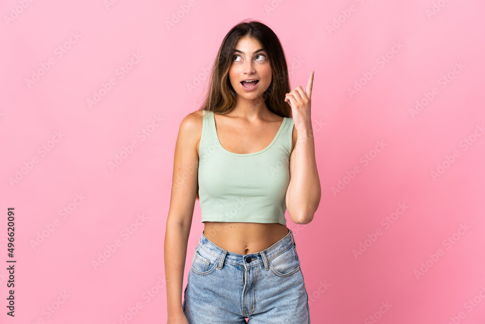 Young caucasian woman isolated on pink background thinking an idea pointing the finger up Young caucasian woman isolated on pink background thinking an idea pointing the finger up