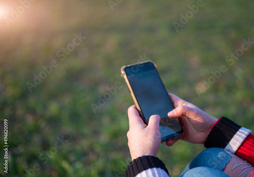 Close up shot on the smartphone screen as a young woman's fingers are typing messages. Copy space.