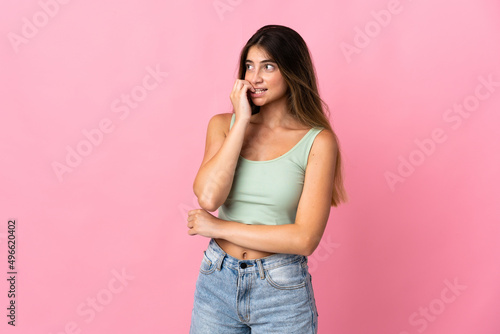 Young caucasian woman isolated on pink background is a little bit nervous © luismolinero