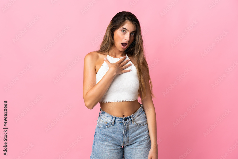 Young caucasian woman isolated on pink background surprised and shocked while looking right Young caucasian woman isolated on pink background surprised and shocked while looking right