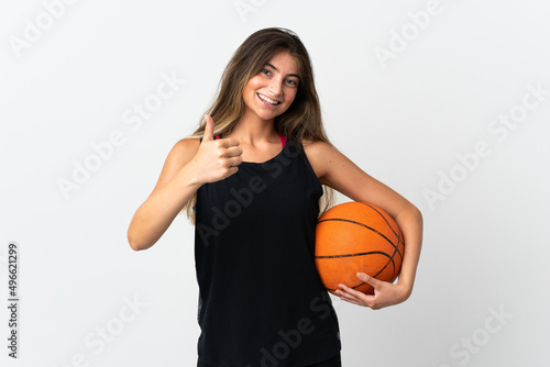 Young caucasian woman isolated on white background playing basketball and with thumb up
