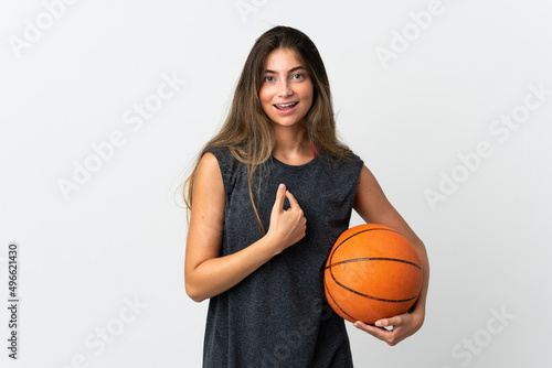 Young woman playing basketball isolated on white background with surprise facial expression © luismolinero