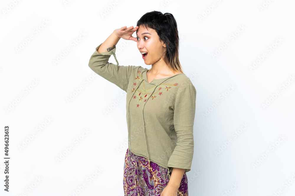 Young Uruguayan girl over isolated white background with surprise expression while looking side Young Uruguayan girl over isolated white background with surprise expression while looking side
