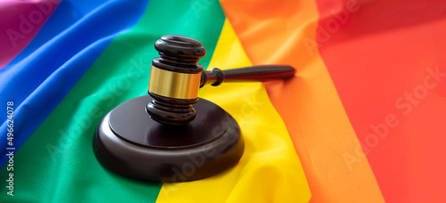 LGBT Law, Gay marriage. Judge gavel on rainbow color textile, close up. Transgender rights