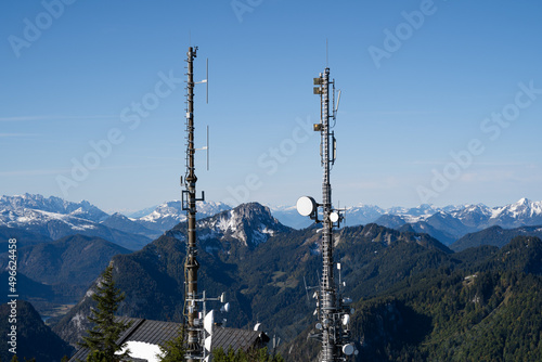 Two radio masts with antennas for mobile devices in the german mountains photo