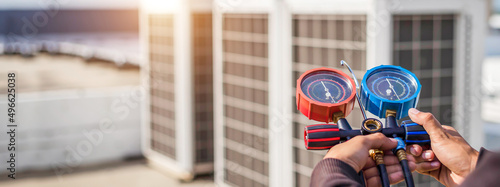 Photography Technician checking the operation of the air conditioner.