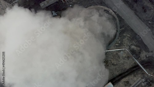 The coal processing factory pollutes the environment with the release of toxic gases. Evening sunset and blue sea Drone removes the chimney releases black smoke.